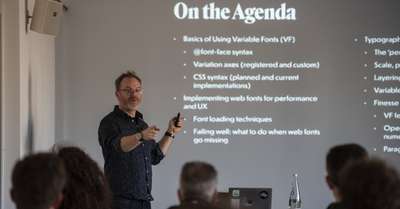 Jason in front of a screen with the workshop agenda showing on it