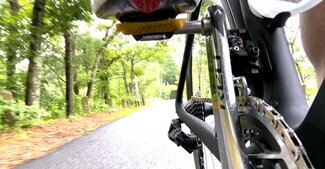 View of the crankset, chain, and pedal while riding