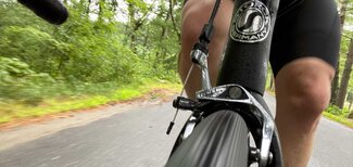 View from the front: closeup of the front tire, brake, and me while riding