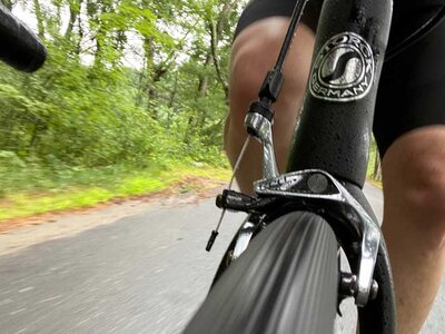 View from the front: closeup of the front tire, brake, and me while riding